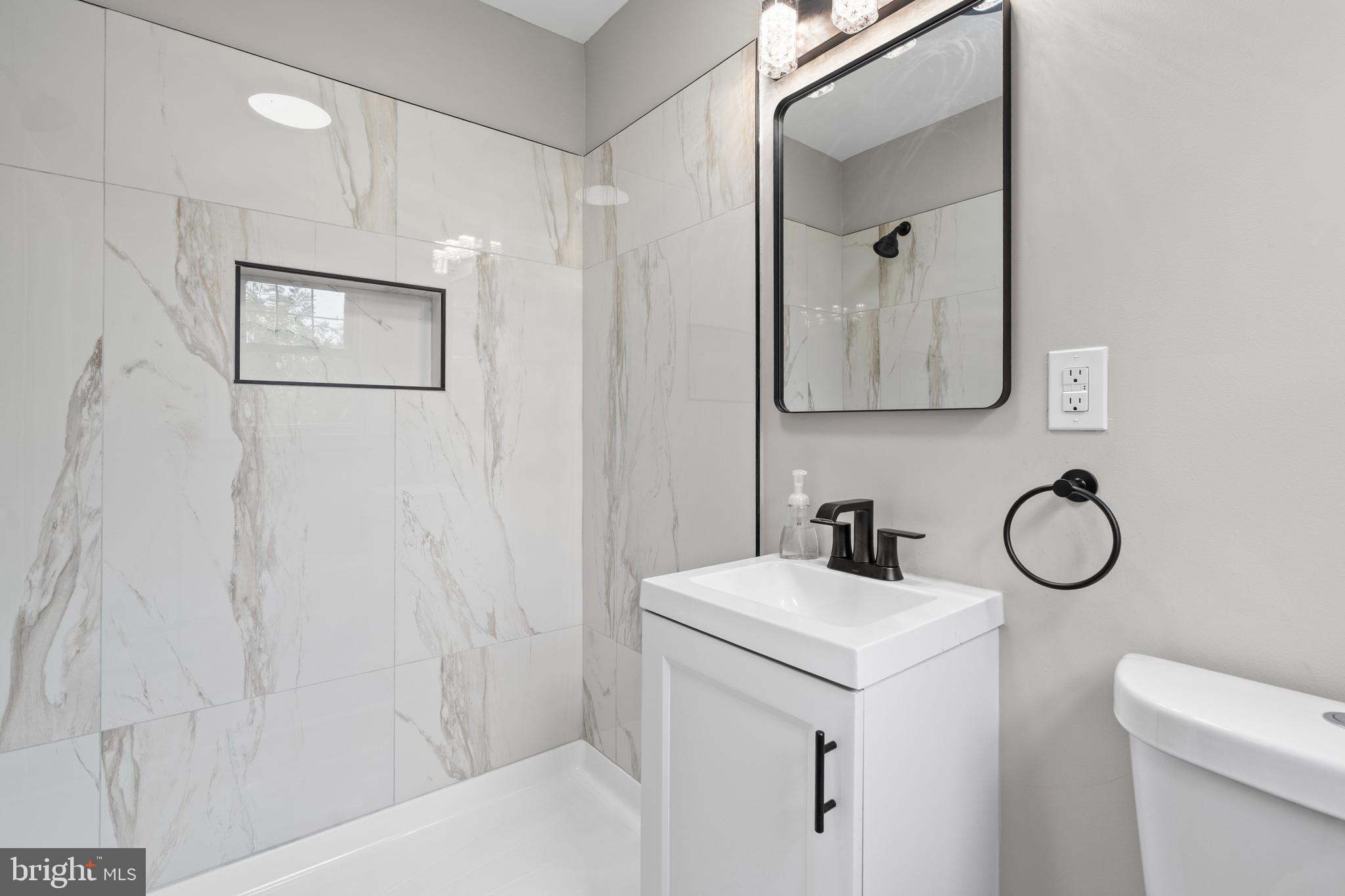 131 Lippincott Avenue Riverside, NJ 08075 - Photo 18 of 34 a bathroom with a sink a toilet and shower