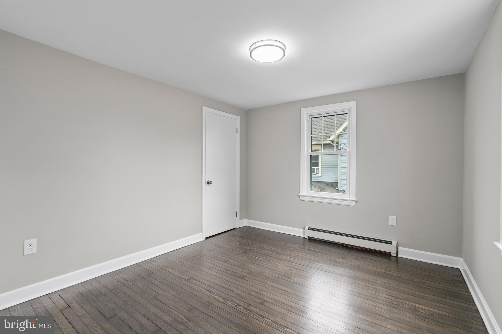 131 Lippincott Avenue Riverside, NJ 08075 - Photo 21 of 34 an empty room with wooden floor and windows