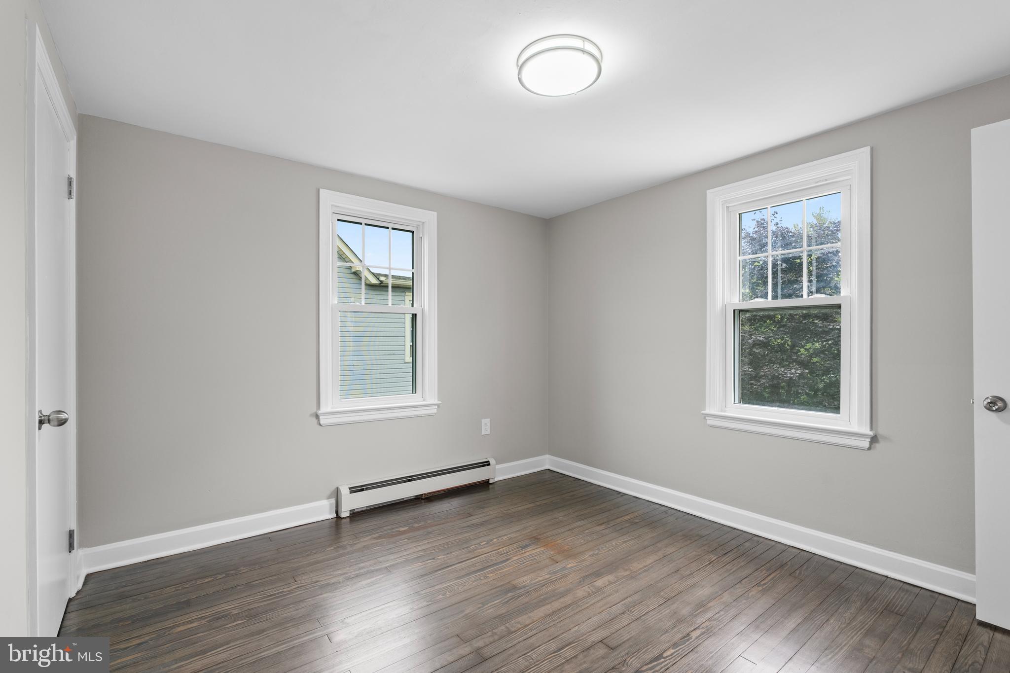131 Lippincott Avenue Riverside, NJ 08075 - Photo 22 of 34 an empty room with a window and wooden floor