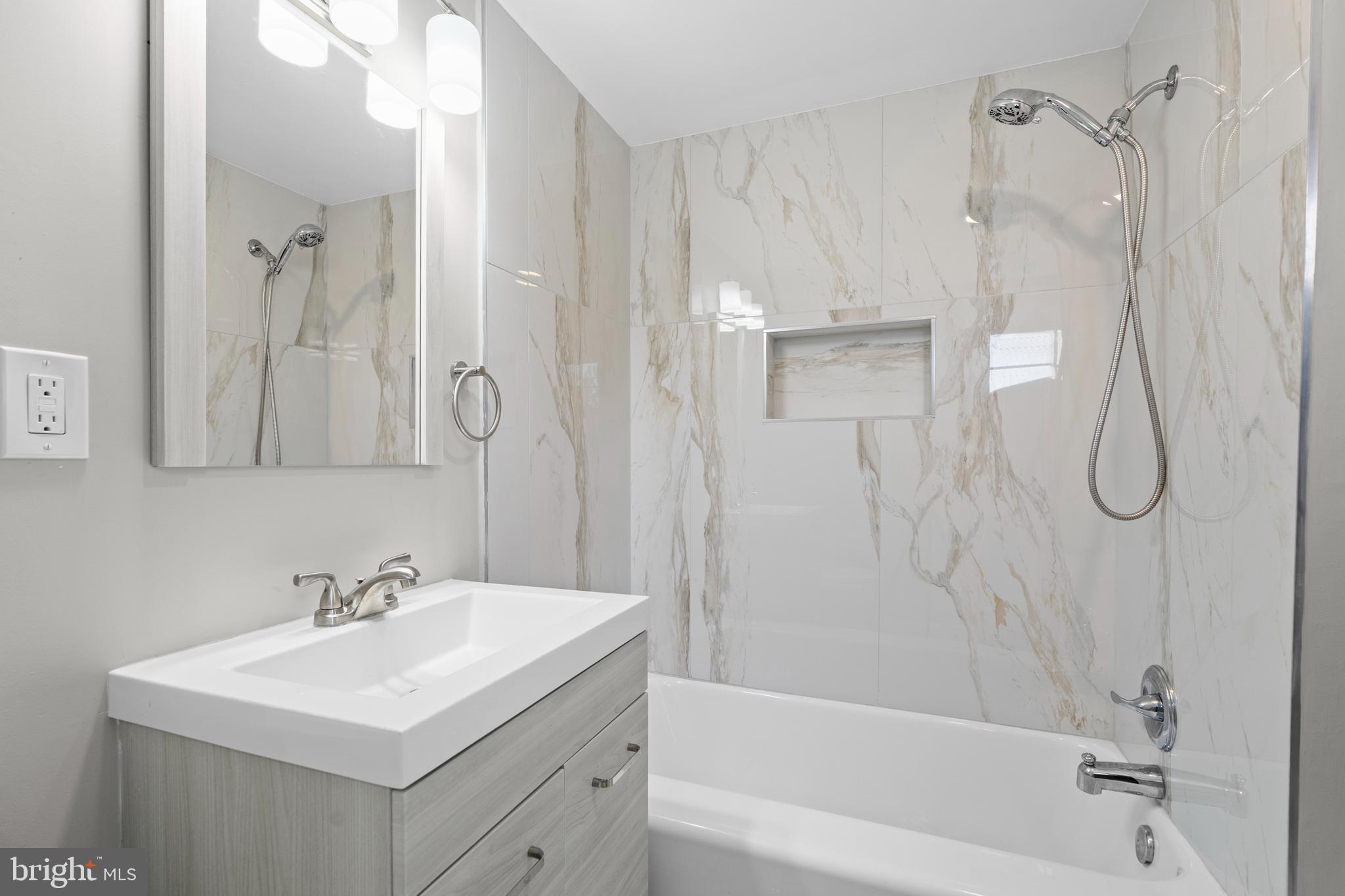 131 Lippincott Avenue Riverside, NJ 08075 - Photo 24 of 34 a bathroom with a shower a sink and a mirror