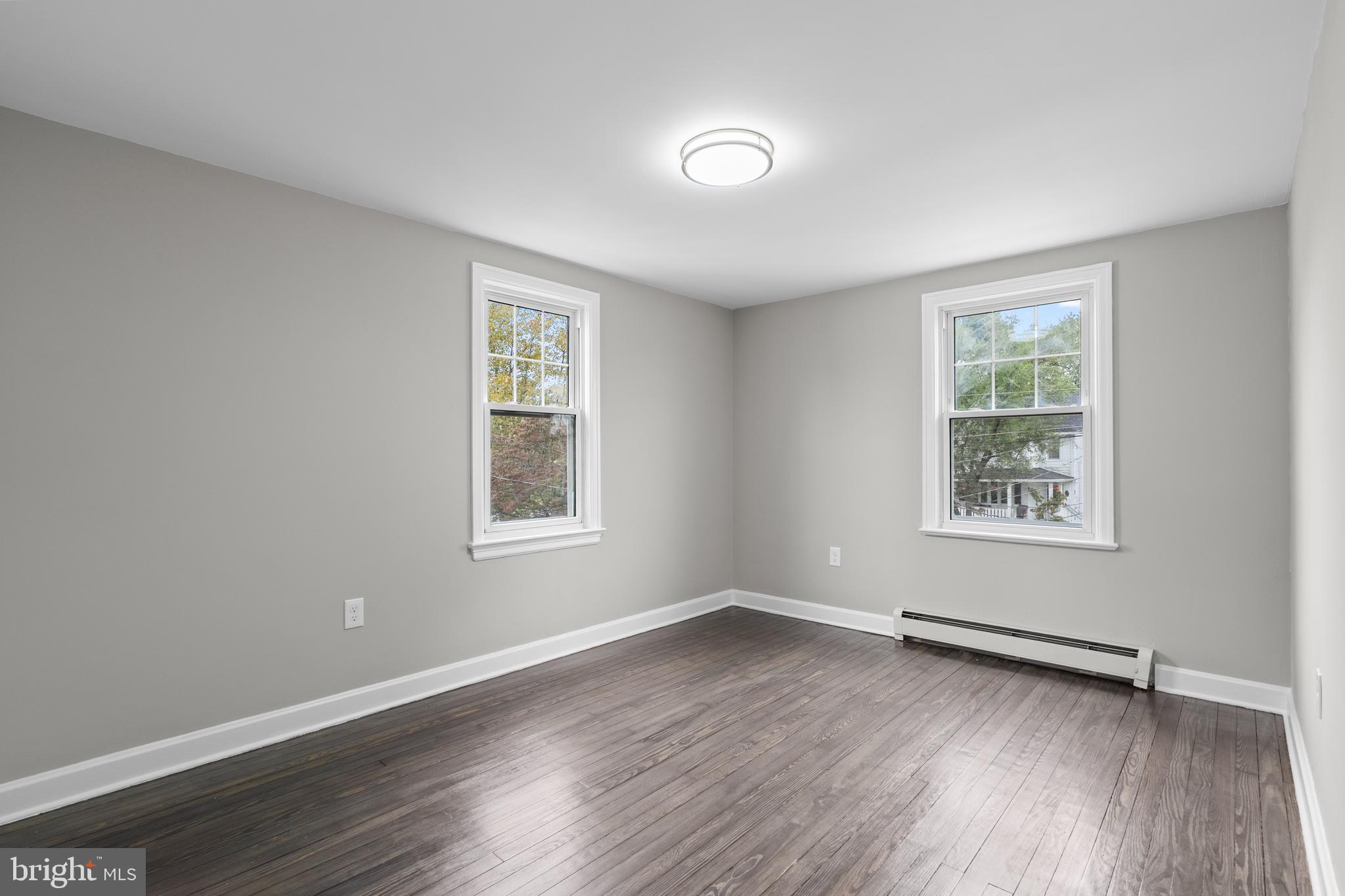 131 Lippincott Avenue Riverside, NJ 08075 - Photo 25 of 34 a view of an empty room with wooden floor and a window