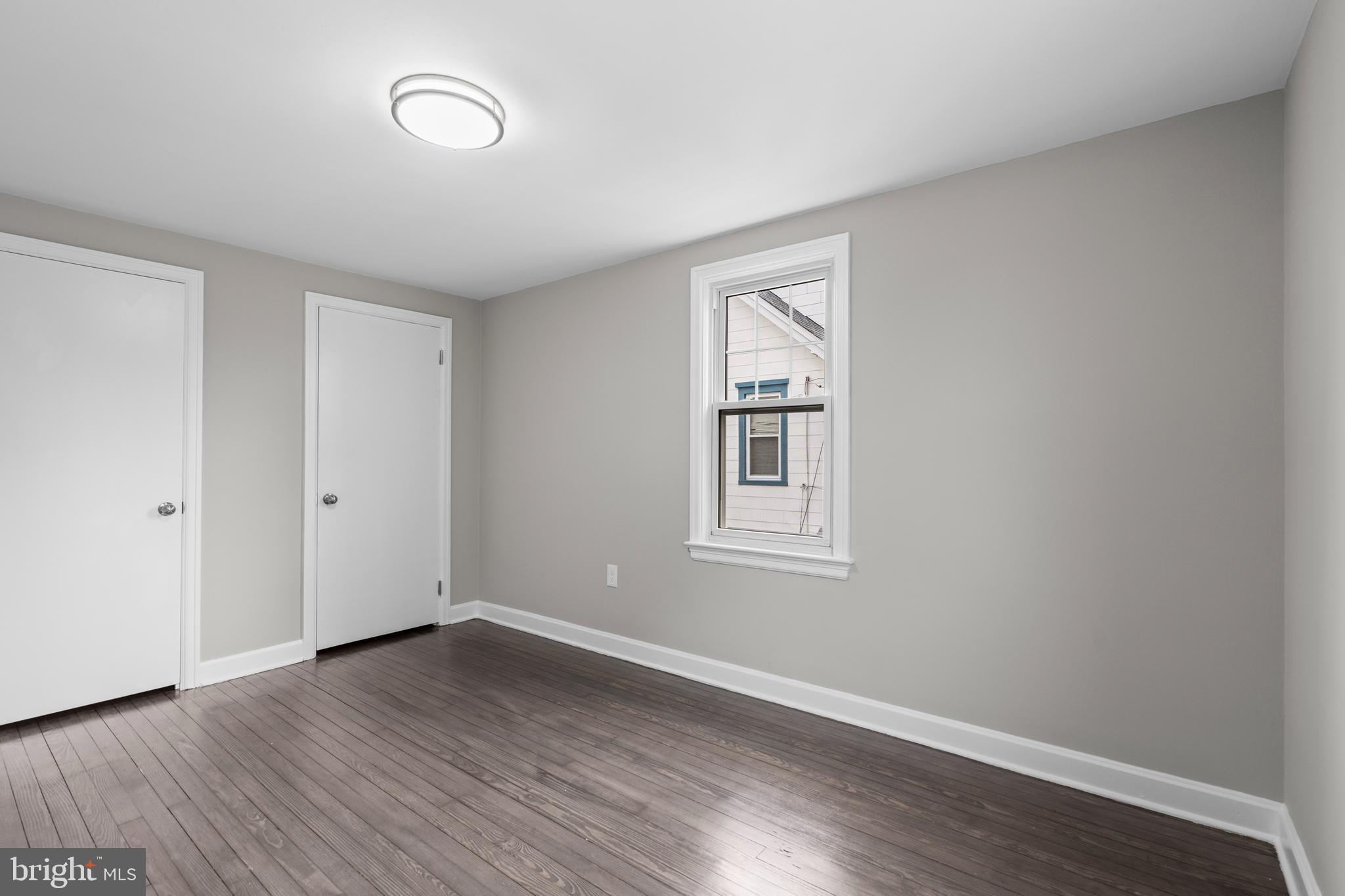 131 Lippincott Avenue Riverside, NJ 08075 - Photo 26 of 34 an empty room with wooden floor and windows