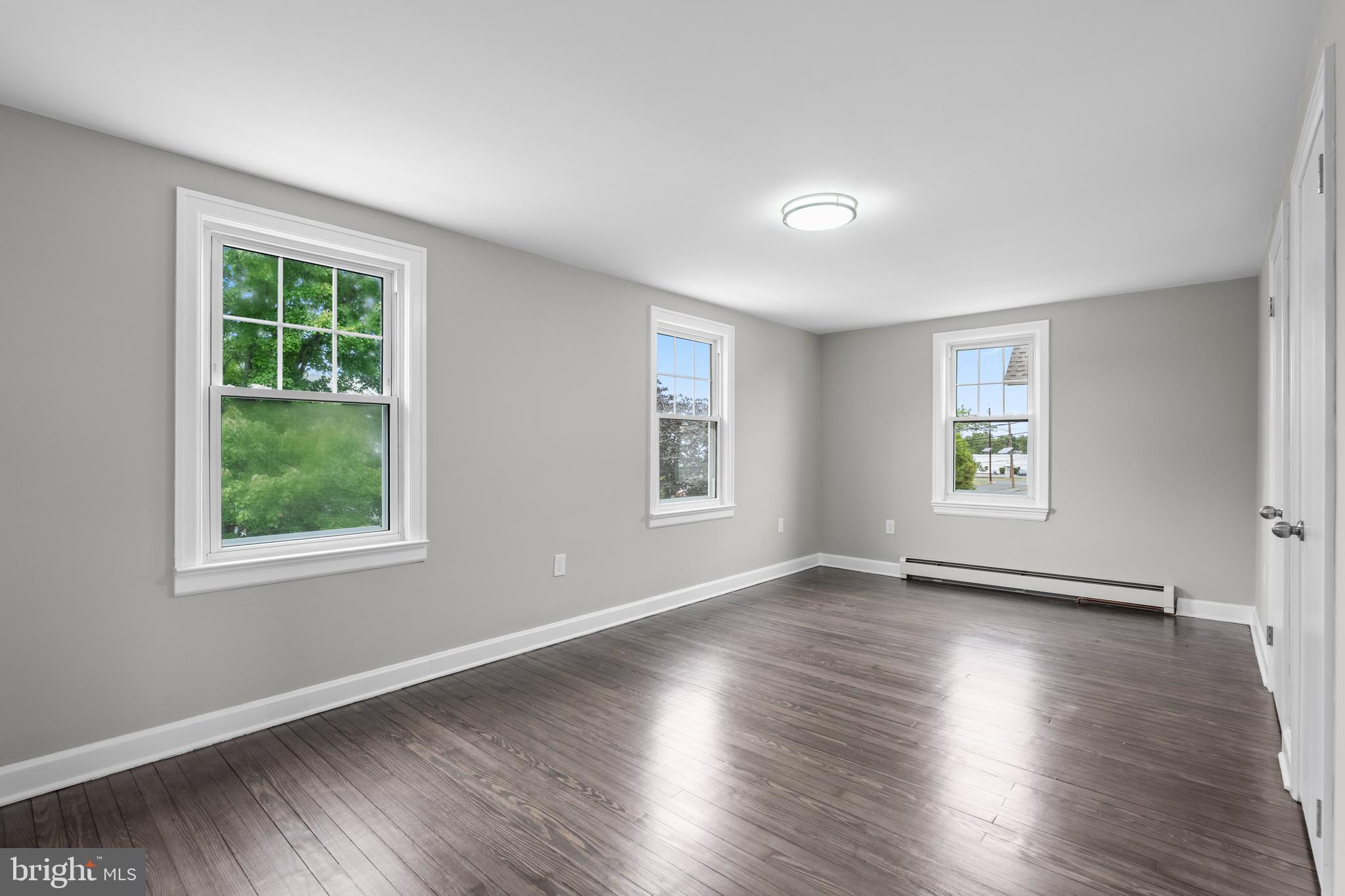 131 Lippincott Avenue Riverside, NJ 08075 - Photo 27 of 34 a view of an empty room with wooden floor and a window