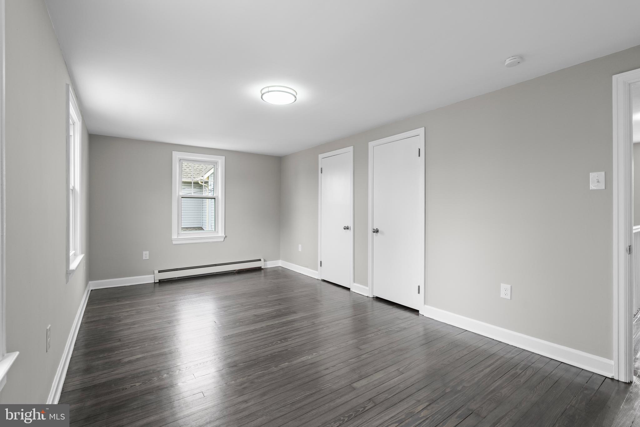 131 Lippincott Avenue Riverside, NJ 08075 - Photo 28 of 34 an empty room with wooden floor and windows