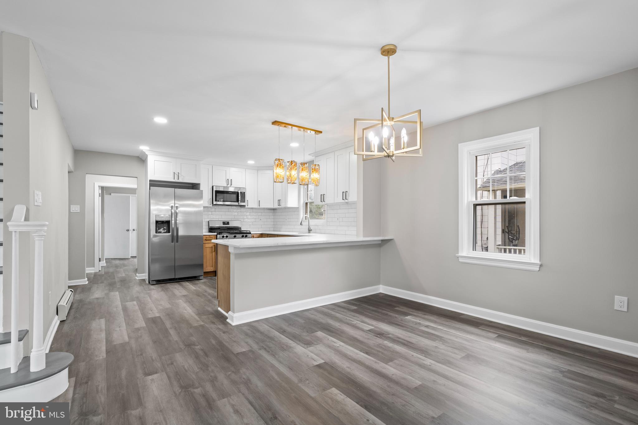 131 Lippincott Avenue Riverside, NJ 08075 - Photo 9 of 34 a view of a kitchen with wooden floor and a window