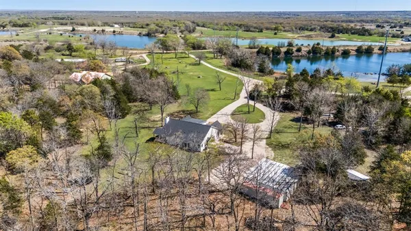 an aerial view of a house with a lake view