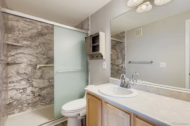 a bathroom with a sink toilet and shower