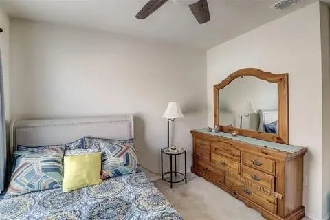 a bedroom with a bed and a dresser
