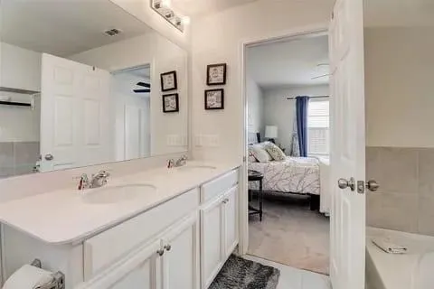 a en suite bathroom with a sink and a mirror