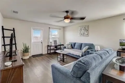 a living room with furniture and a large mirror