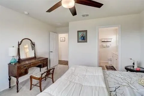 a bedroom with a bed and a desk