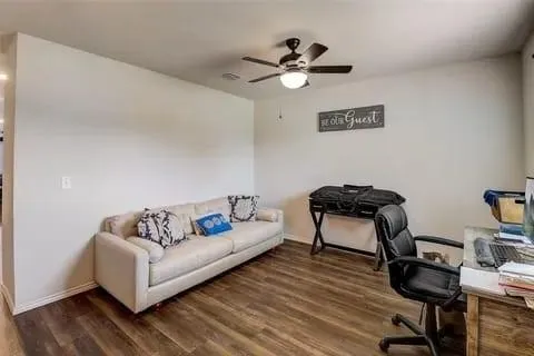 a living room with furniture and wooden floor