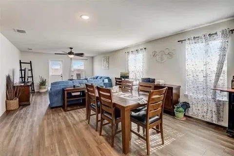 a view of a dining room with furniture and wooden floor