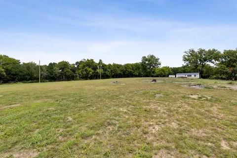 a view of a field with an ocean view