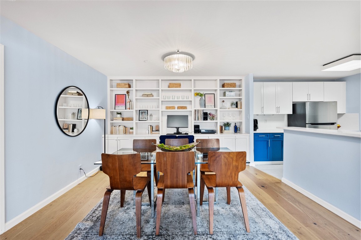 40 North Interstate Highway 35, Unit 2B2 Austin, TX 78701 - Photo 2 of 14 Dining space featuring light wood finished floors and a chandelier