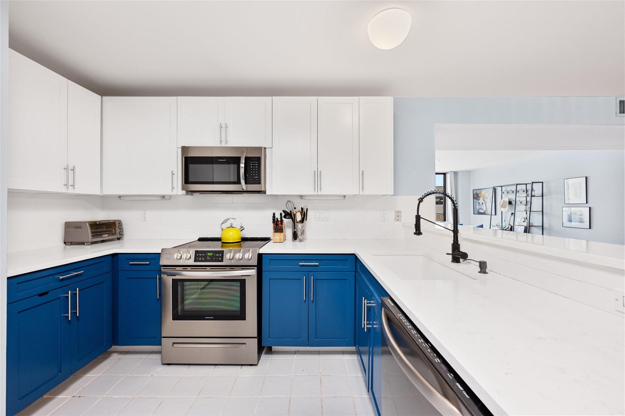 40 North Interstate Highway 35, Unit 2B2 Austin, TX 78701 - Photo 3 of 14 The kitchen features a functional and stylish design. It includes a pantry for storage convenience, an oven with a stovetop, and a microwave for cooking versatility.