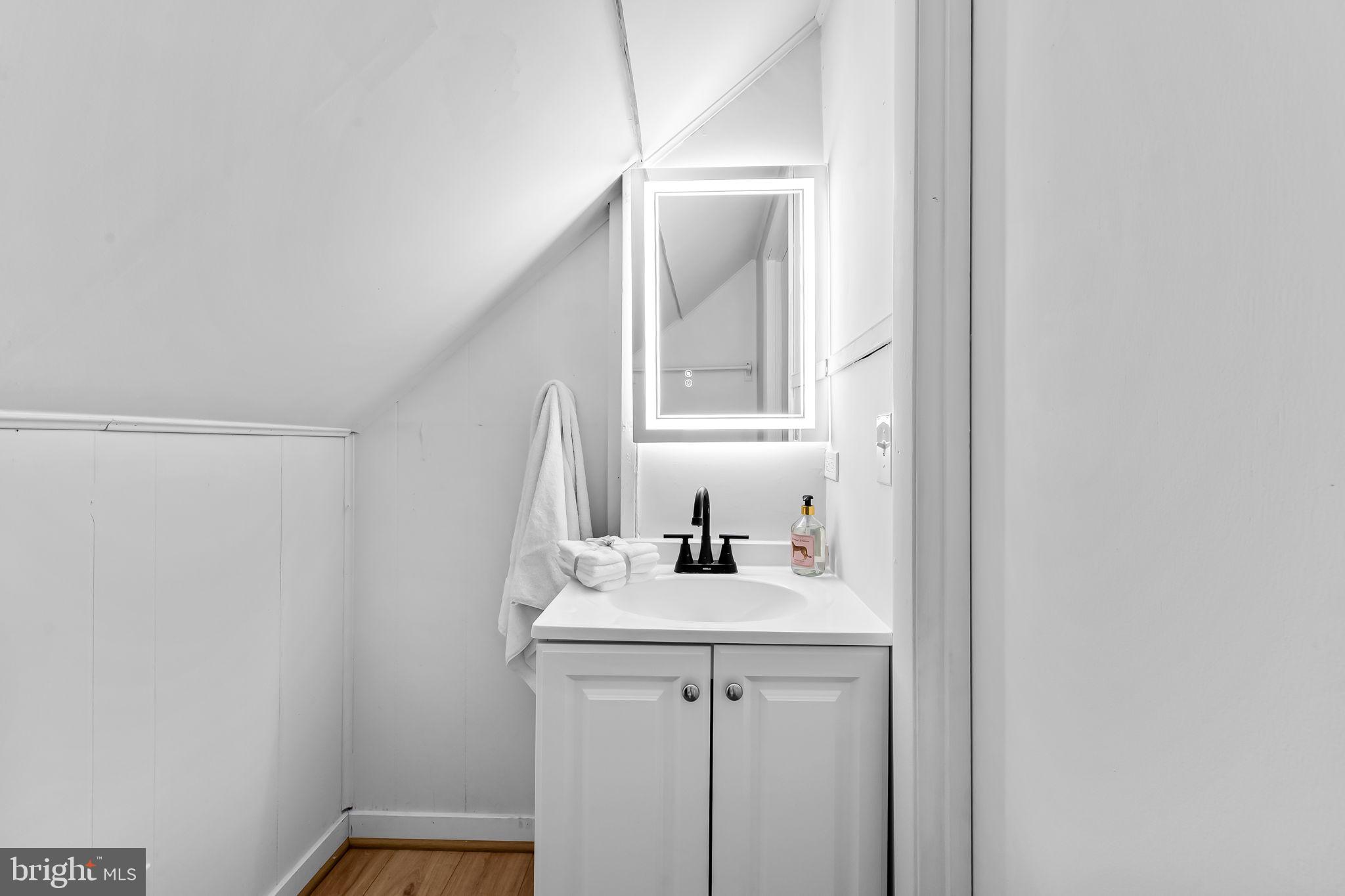 2511 Wentworth Road Baltimore, MD 21234 - Photo 20 of 24 a bathroom with a sink a vanity and a mirror