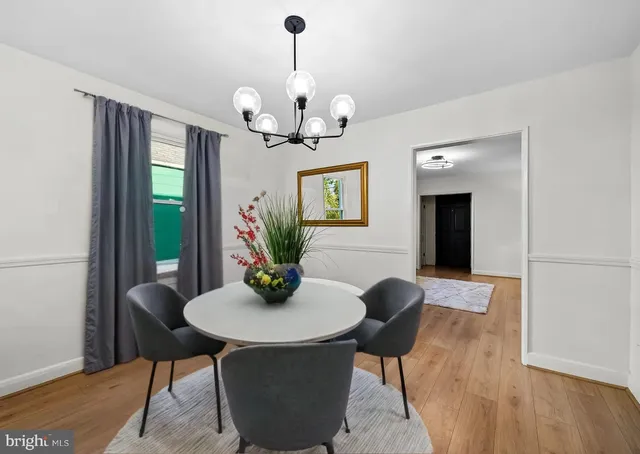 a view of a dining room with furniture wooden floor and chandelier
