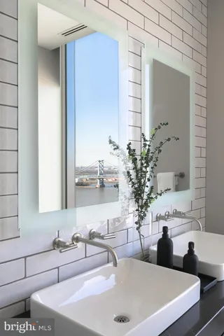 a bathroom with a double vanity sink and a mirror