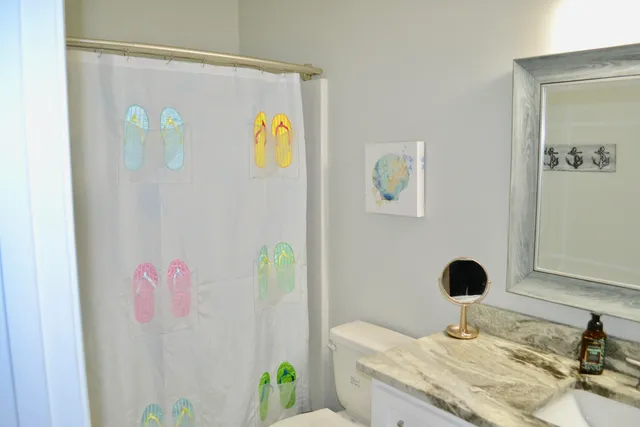 a bathroom with a granite countertop sink a mirror and vanity