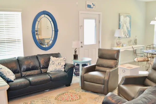 a living room with furniture and a large mirror