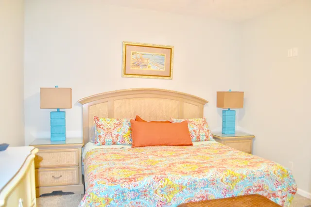 a bedroom with a bed and lamp