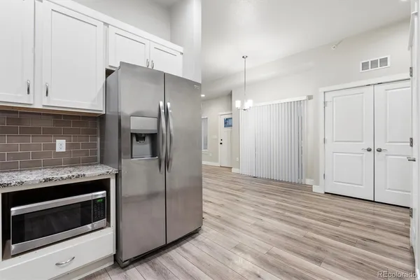 a kitchen with granite countertop wooden cabinets and stainless steel appliances