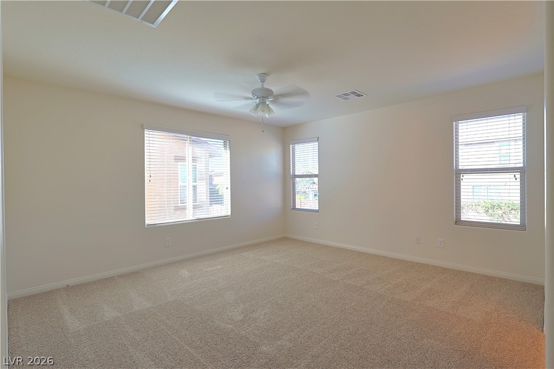 8663 Reynolds Spring Street Las Vegas, NV 89178 - Photo 18 of 32 Plentiful natural light fills this carpeted space through multiple well-positioned windows.
