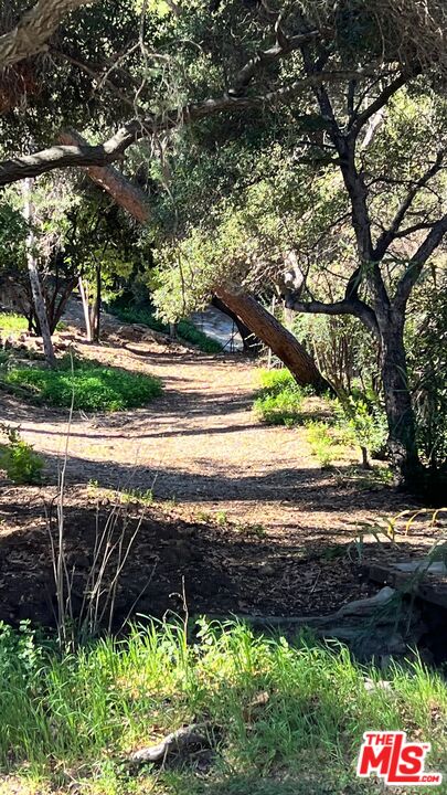 3485 Old Topanga Canyon Road Calabasas, CA 91302 - Photo 16 of 17 a view of a yard with wooden fence