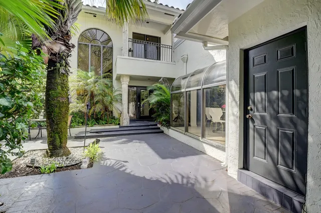 a view of a patio with table and chairs and potted plants