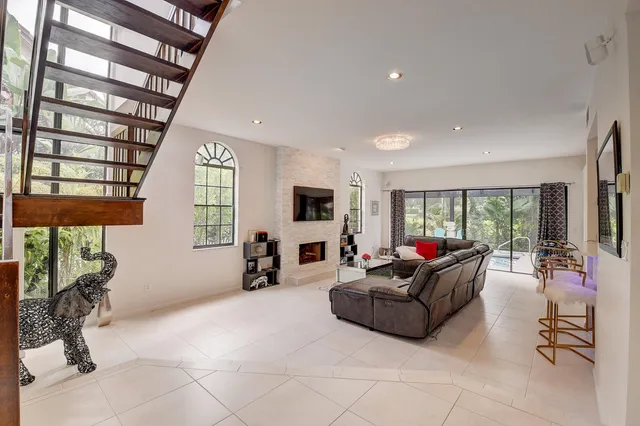 a living room with furniture window and fireplace