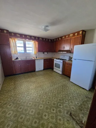 a kitchen with stainless steel appliances kitchen island granite countertop a stove a sink dishwasher and a microwave