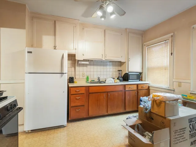 a kitchen with stainless steel appliances granite countertop a refrigerator sink and cabinets