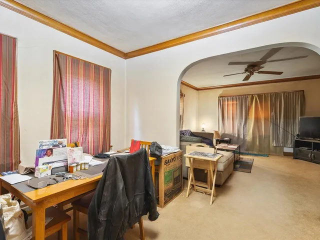 a room with furniture a window and a flat screen tv