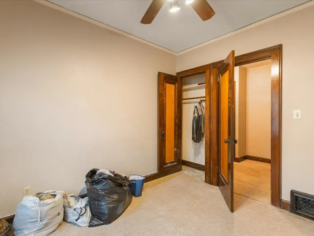 a view of a livingroom with bed and hallway