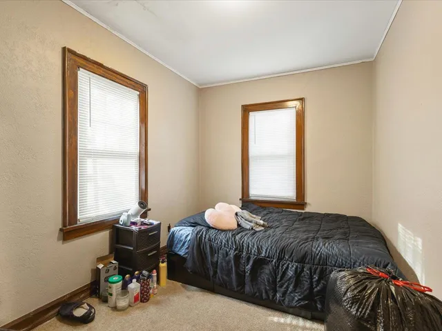 a bedroom with a bed and window