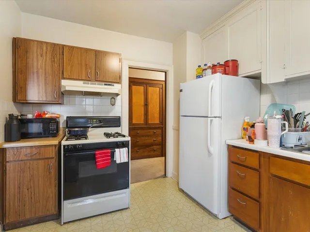 a kitchen with refrigerator a stove a sink and a refrigerator