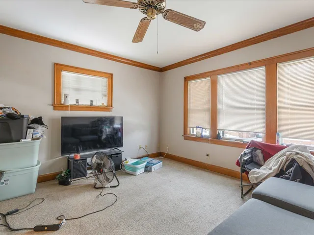 a living room with furniture a ceiling fan