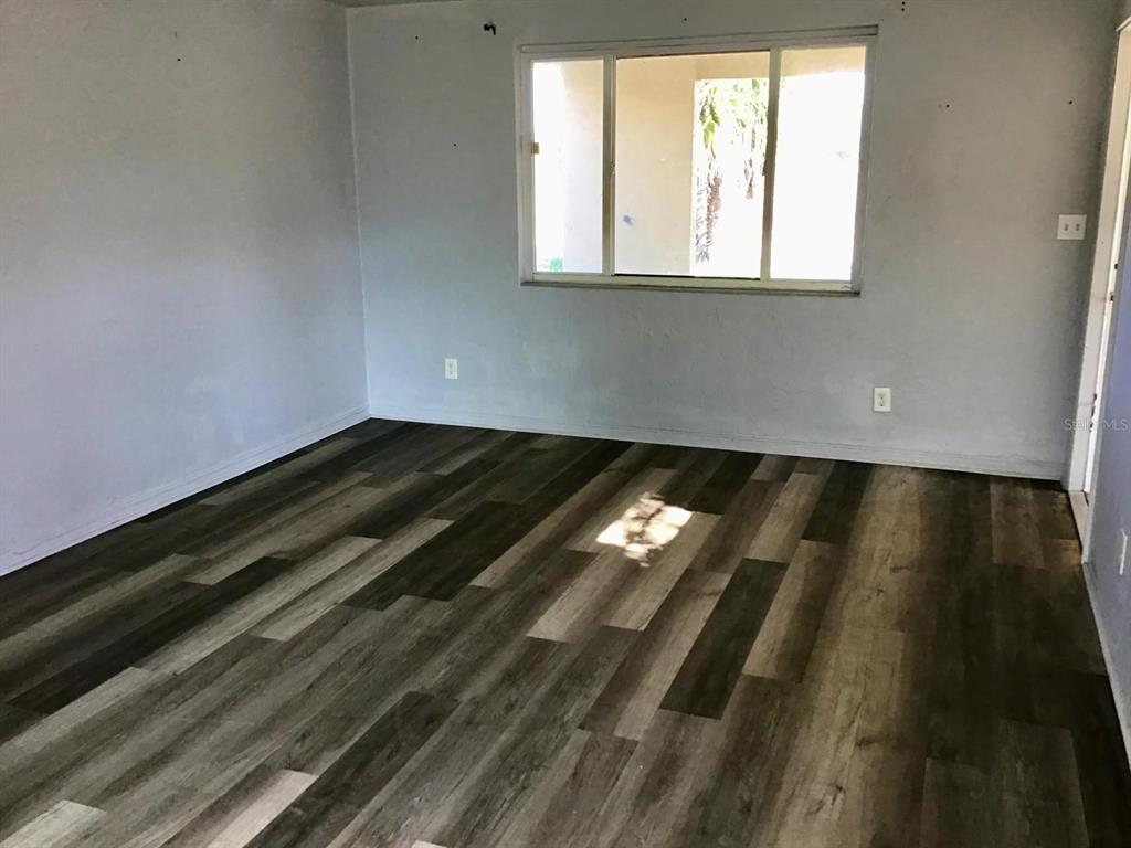 854 Derbyshire Road Daytona Beach, FL 32117 - Photo 2 of 12 a view of an empty room and window