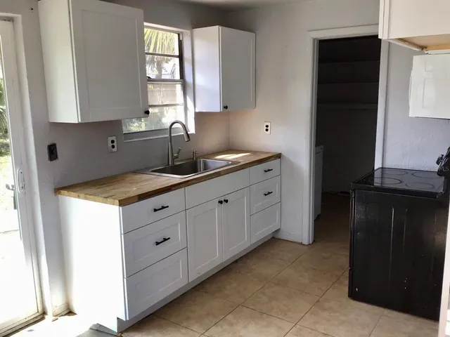 a kitchen with granite countertop cabinets and window