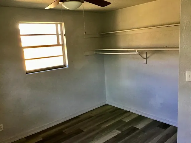 a view of a room with rack on the wall and a window