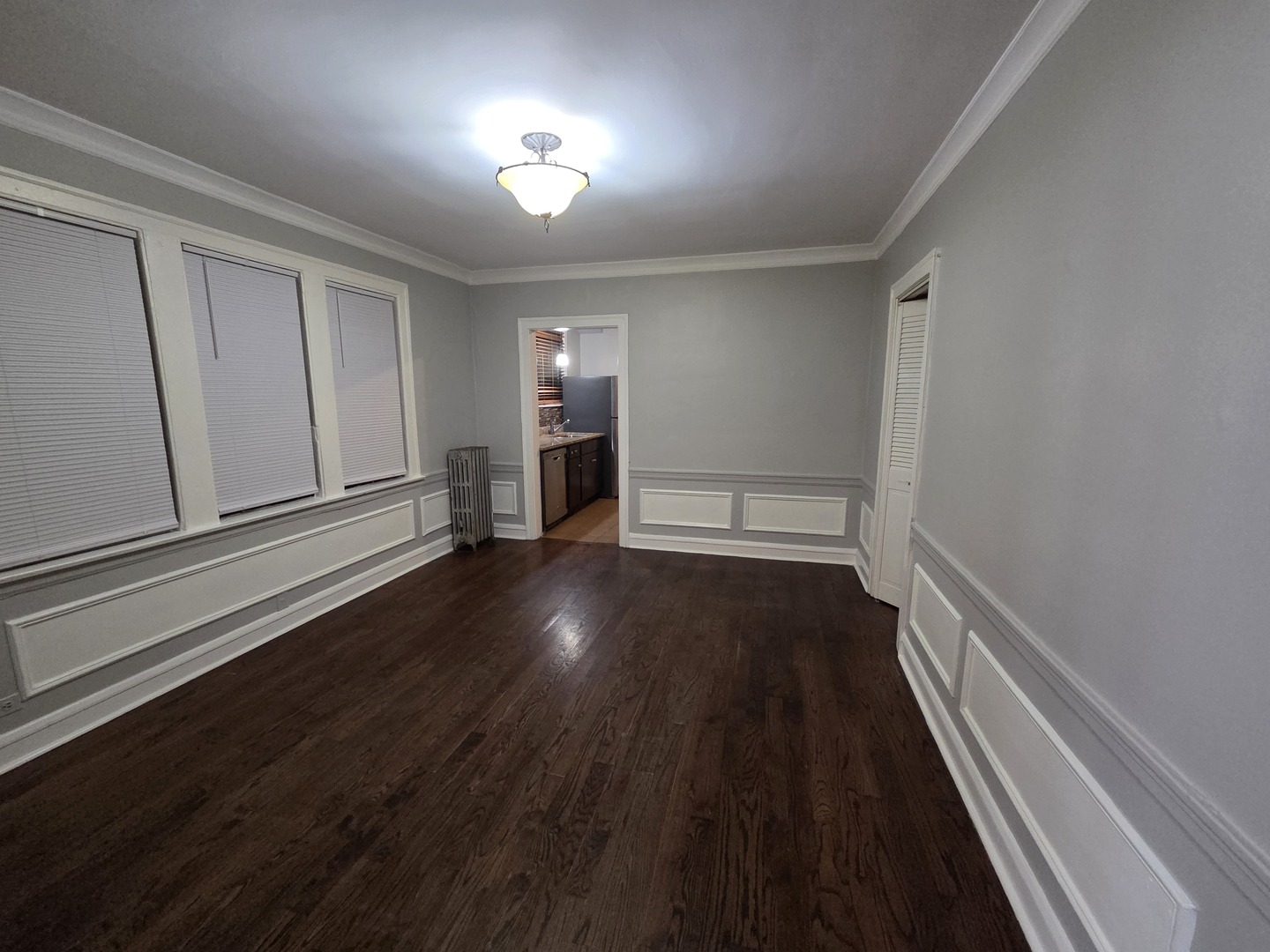 5653 North Spaulding Avenue, Unit 2E Chicago, IL 60659 - Photo 2 of 8 wooden floor in an empty room with a window