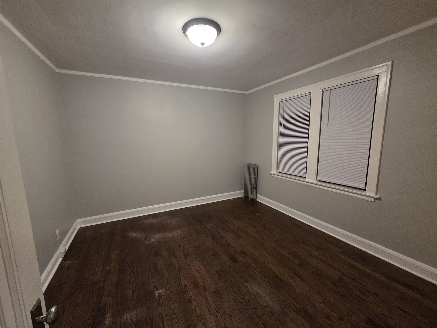 5653 North Spaulding Avenue, Unit 2E Chicago, IL 60659 - Photo 8 of 8 an empty room with wooden floor and windows