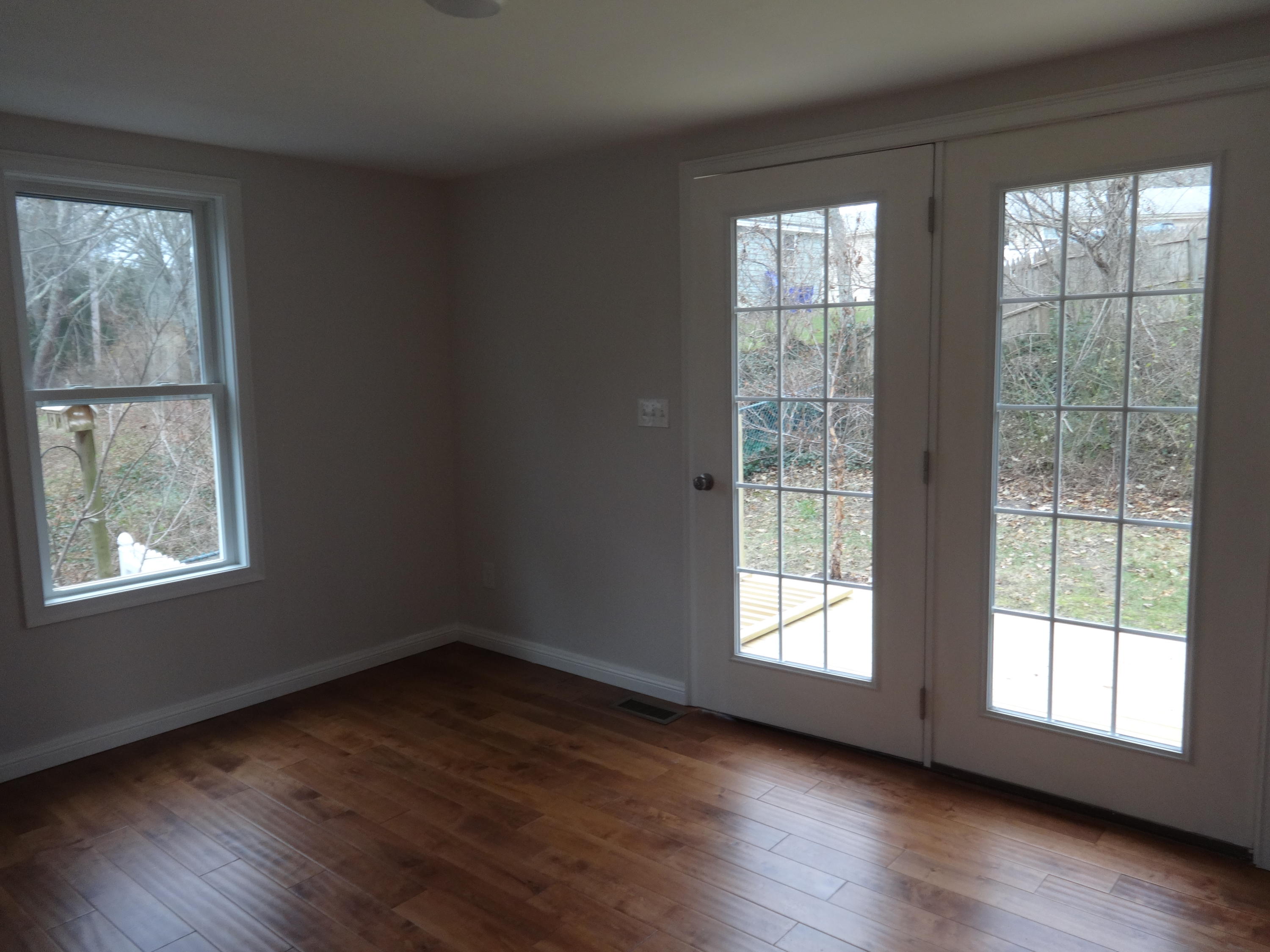 15 Cliff Road Monument Beach, MA 02532 - Photo 14 of 28 a view of an empty room with wooden floor and a window