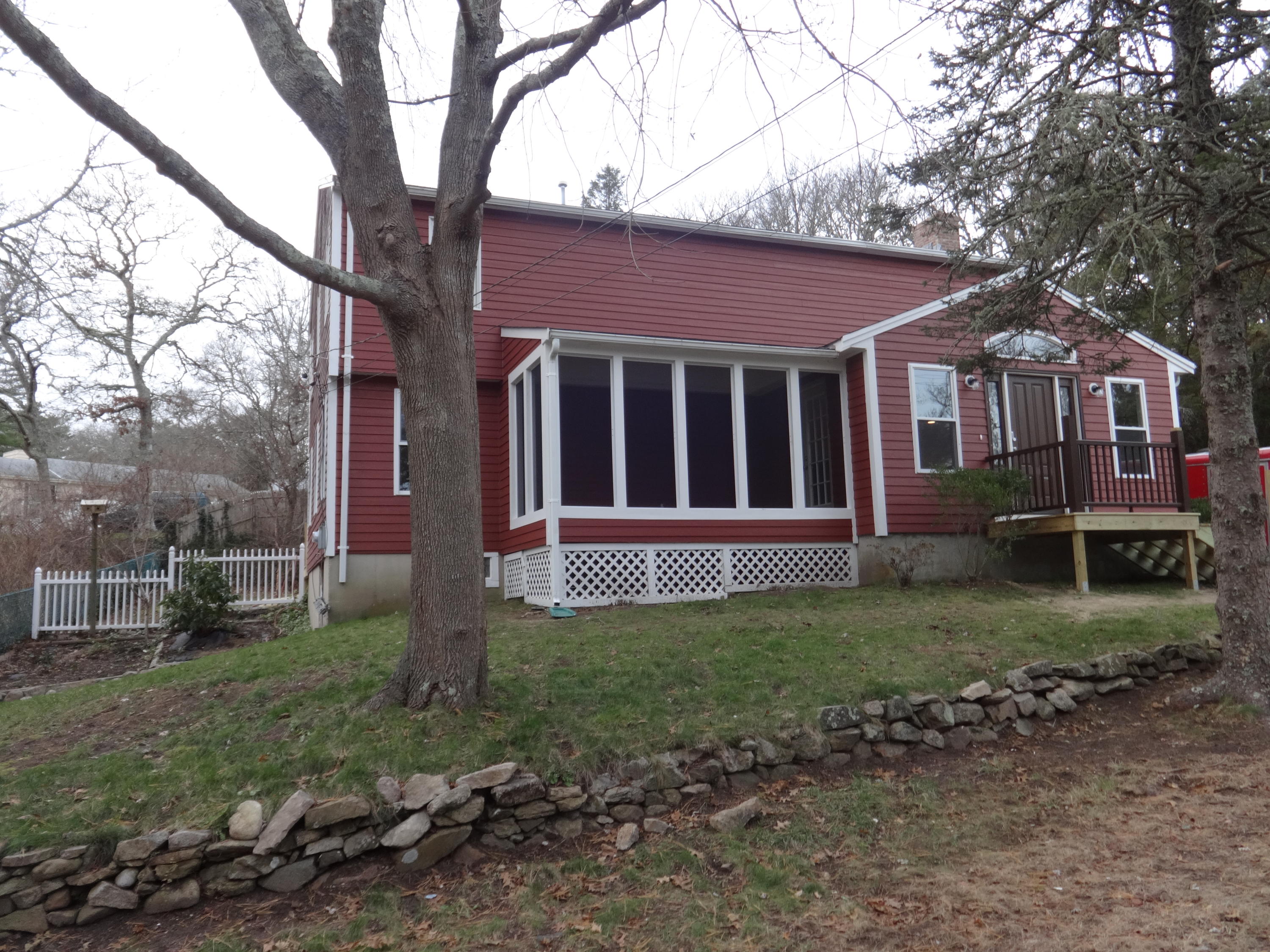 15 Cliff Road Monument Beach, MA 02532 - Photo 2 of 28 a house that has a tree in front of a house