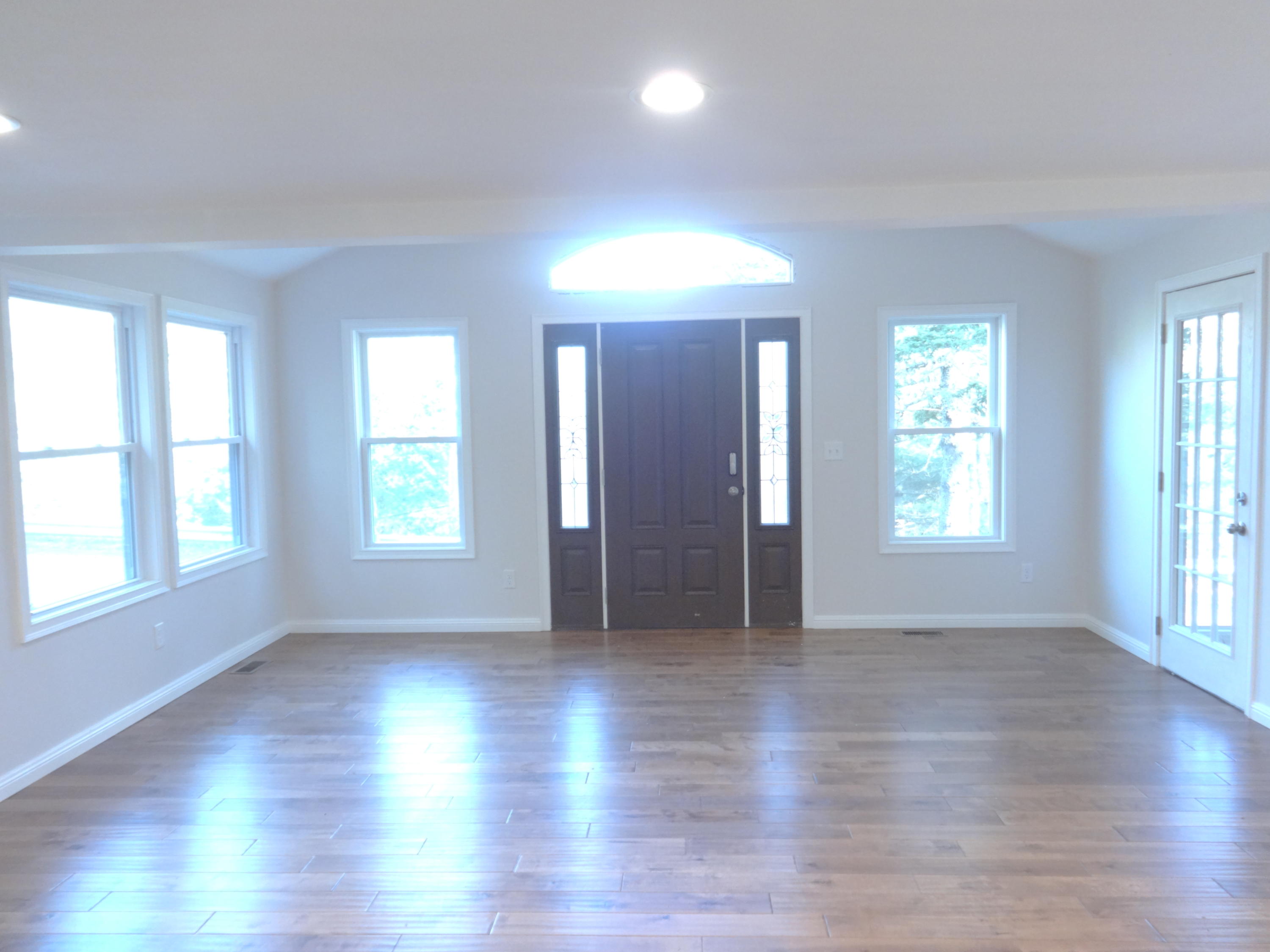 15 Cliff Road Monument Beach, MA 02532 - Photo 5 of 28 an empty room with wooden floor and windows