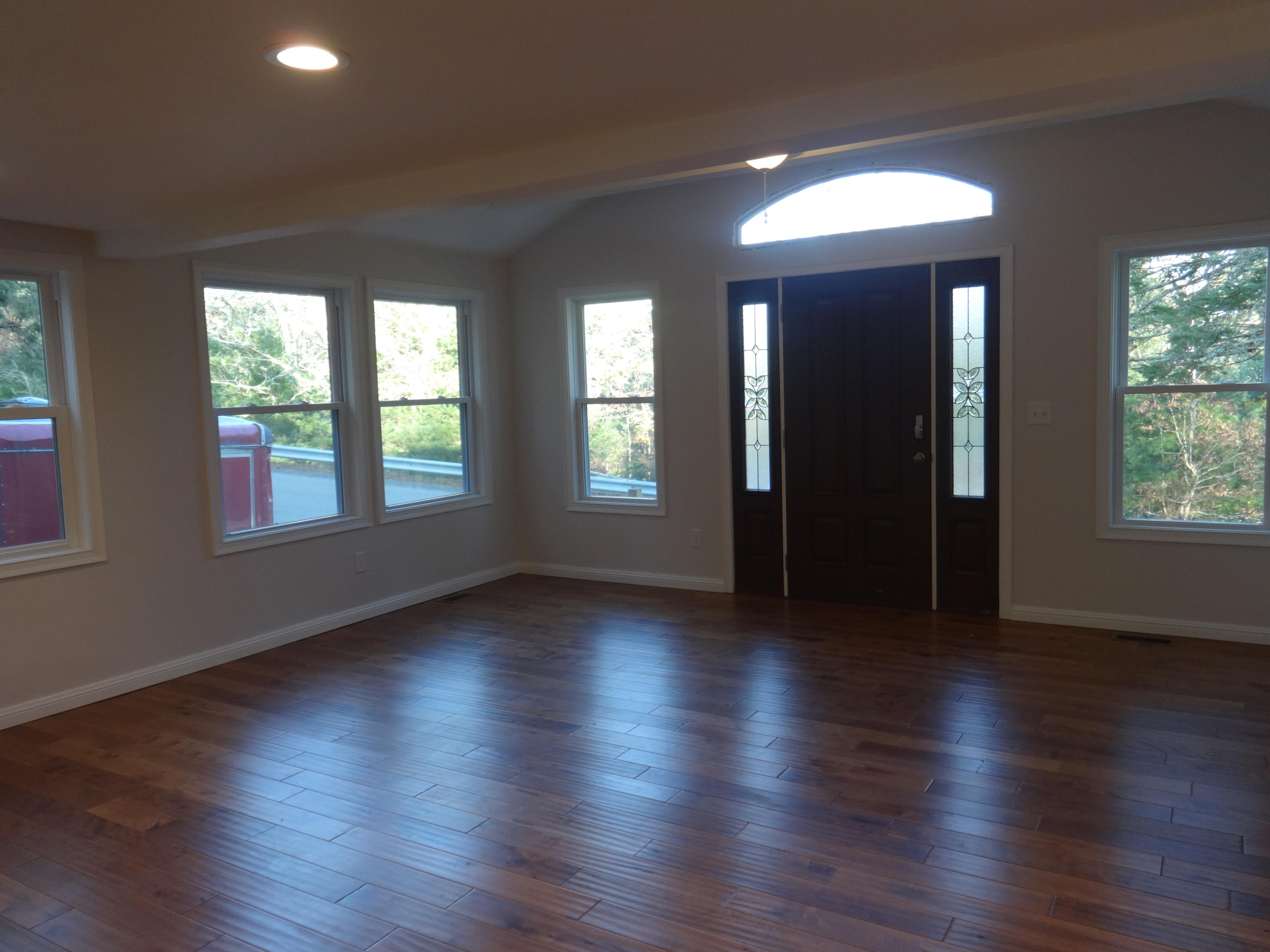 15 Cliff Road Monument Beach, MA 02532 - Photo 6 of 28 an empty room with wooden floor and windows