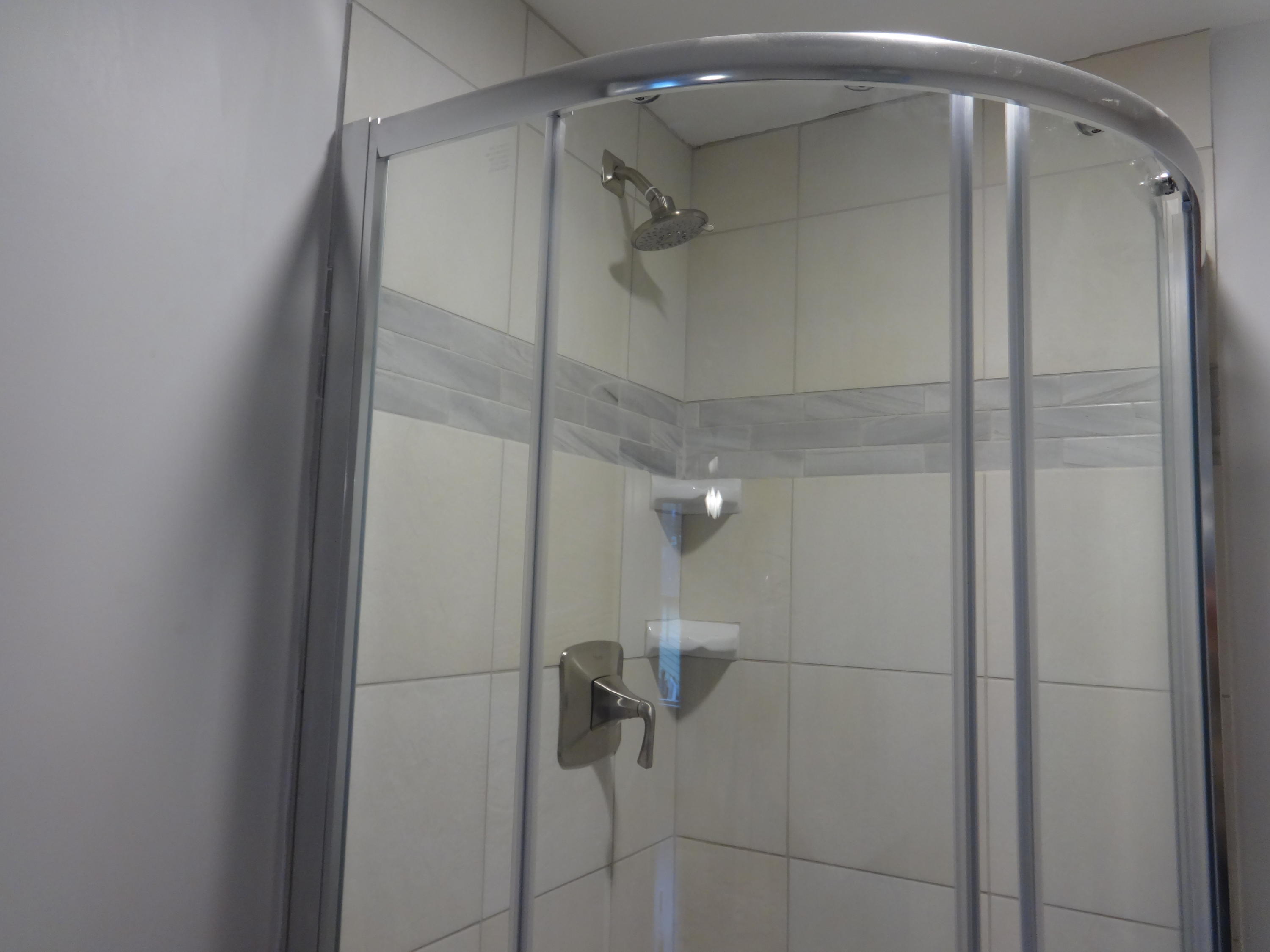 15 Cliff Road Monument Beach, MA 02532 - Photo 9 of 28 a bathroom with a glass shower door