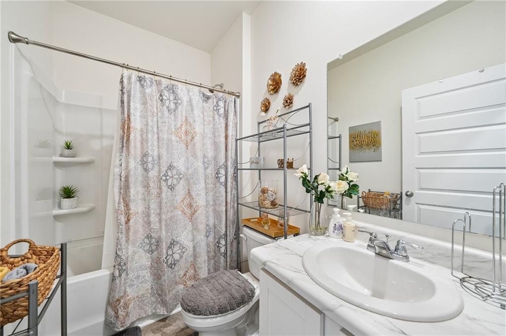 8592 Seabiscuit Road Lithonia, GA 30058 - Photo 15 of 25 a bathroom with a sink toilet and shower