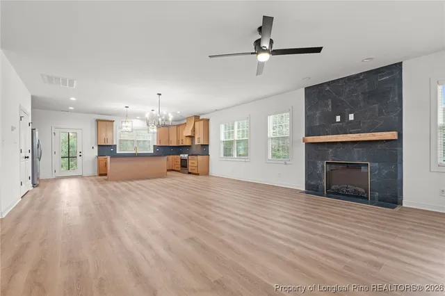 a view of a kitchen with a sink and a fireplace